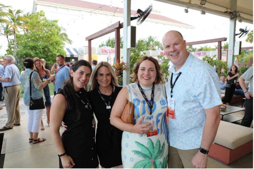 A picture of four people smiling | Planview Connect 2025