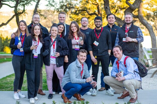 An image of several coworkers posing for a picture.