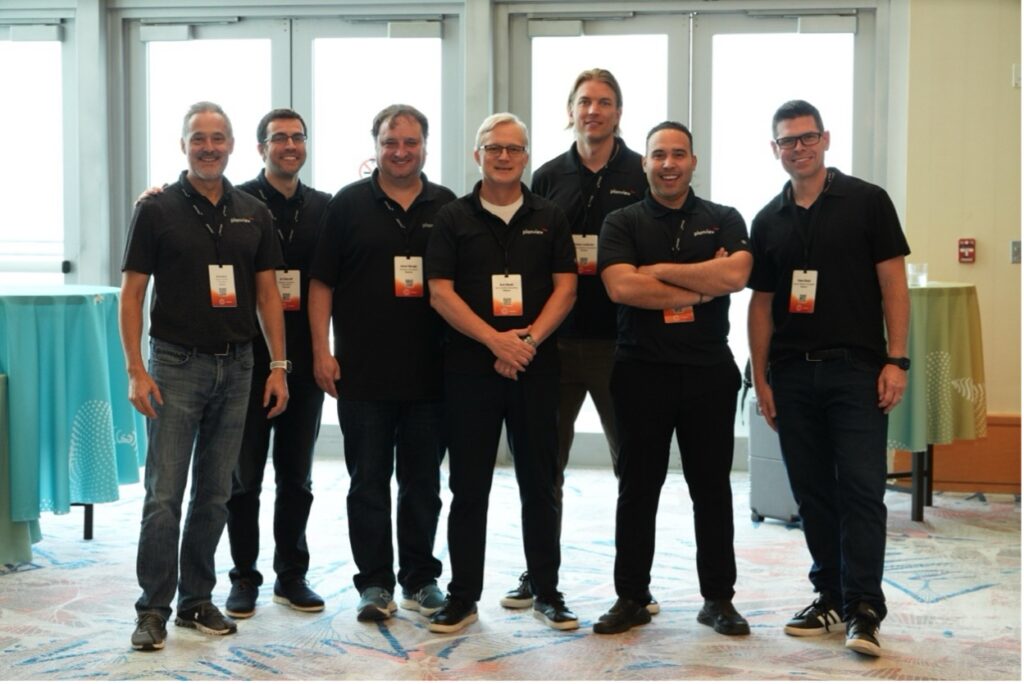 Several men standing and smiling for a picture  | Planview Connect 2025